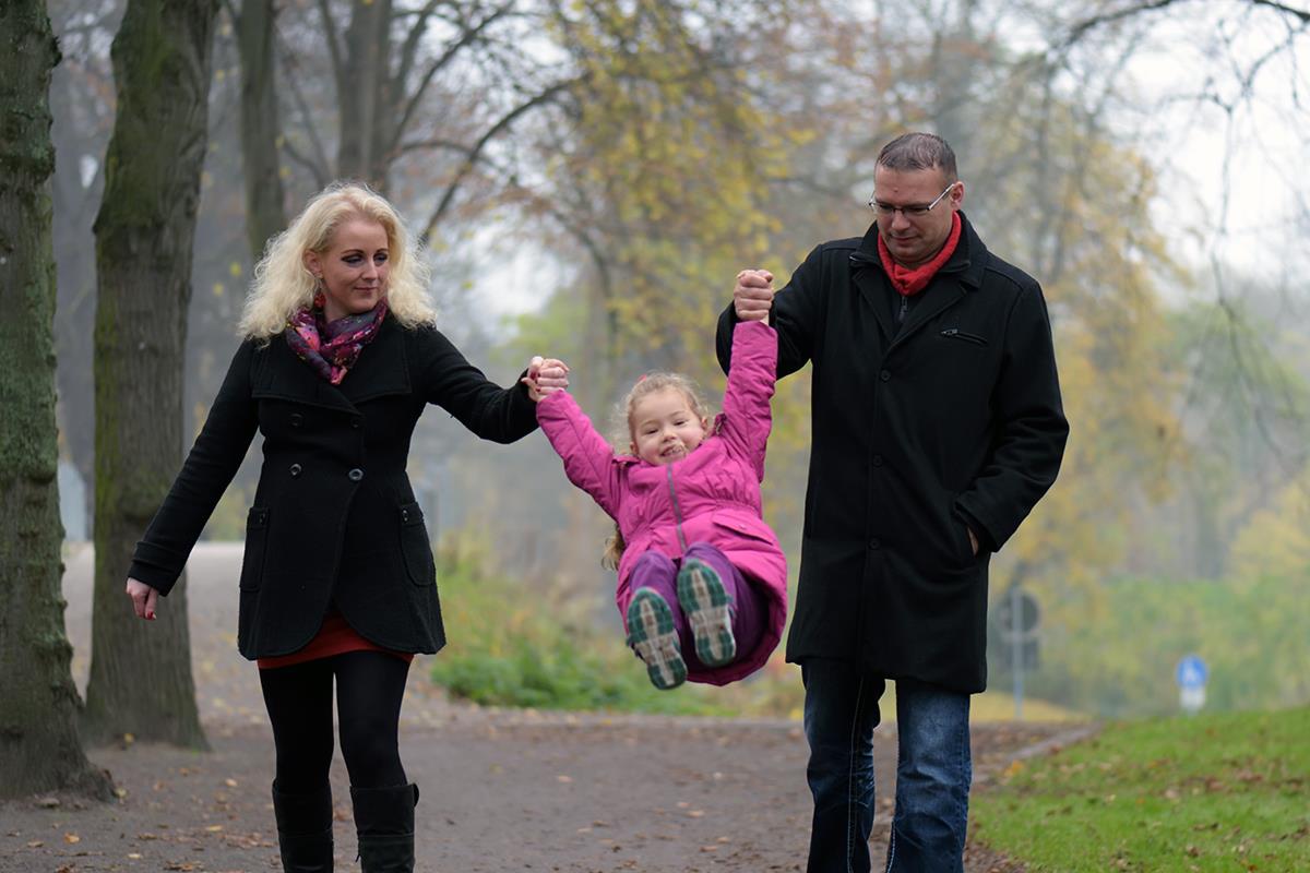 Eltern gehen mit Kind spazieren