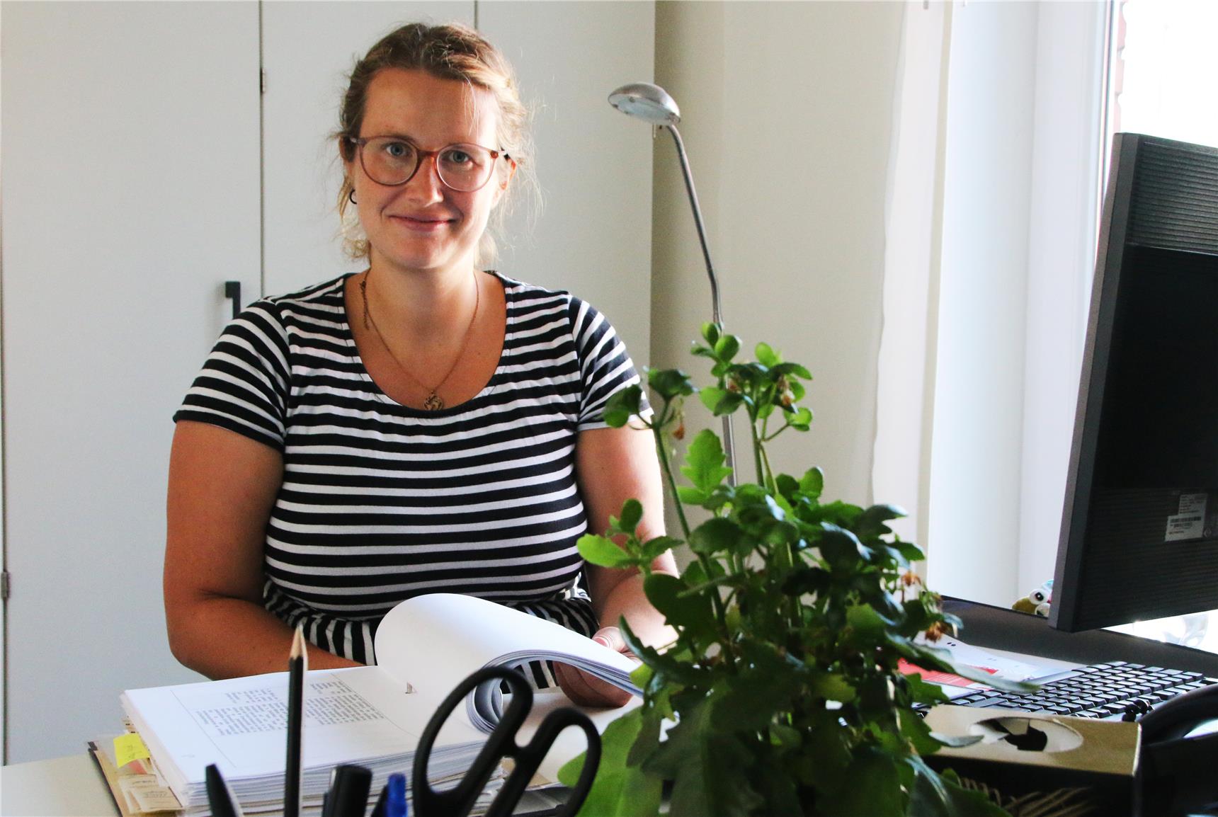 Das Foto zeigt Lena Göckener an ihrem Schreibtisch.